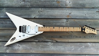 A freshly set up electric guitar resting on a workbench with polished frets gleaming.