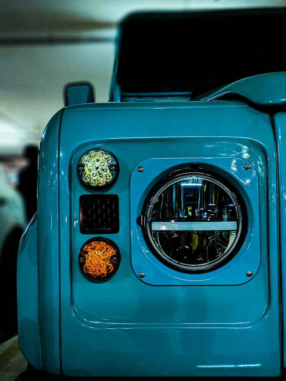 blue and silver car with yellow and black round light