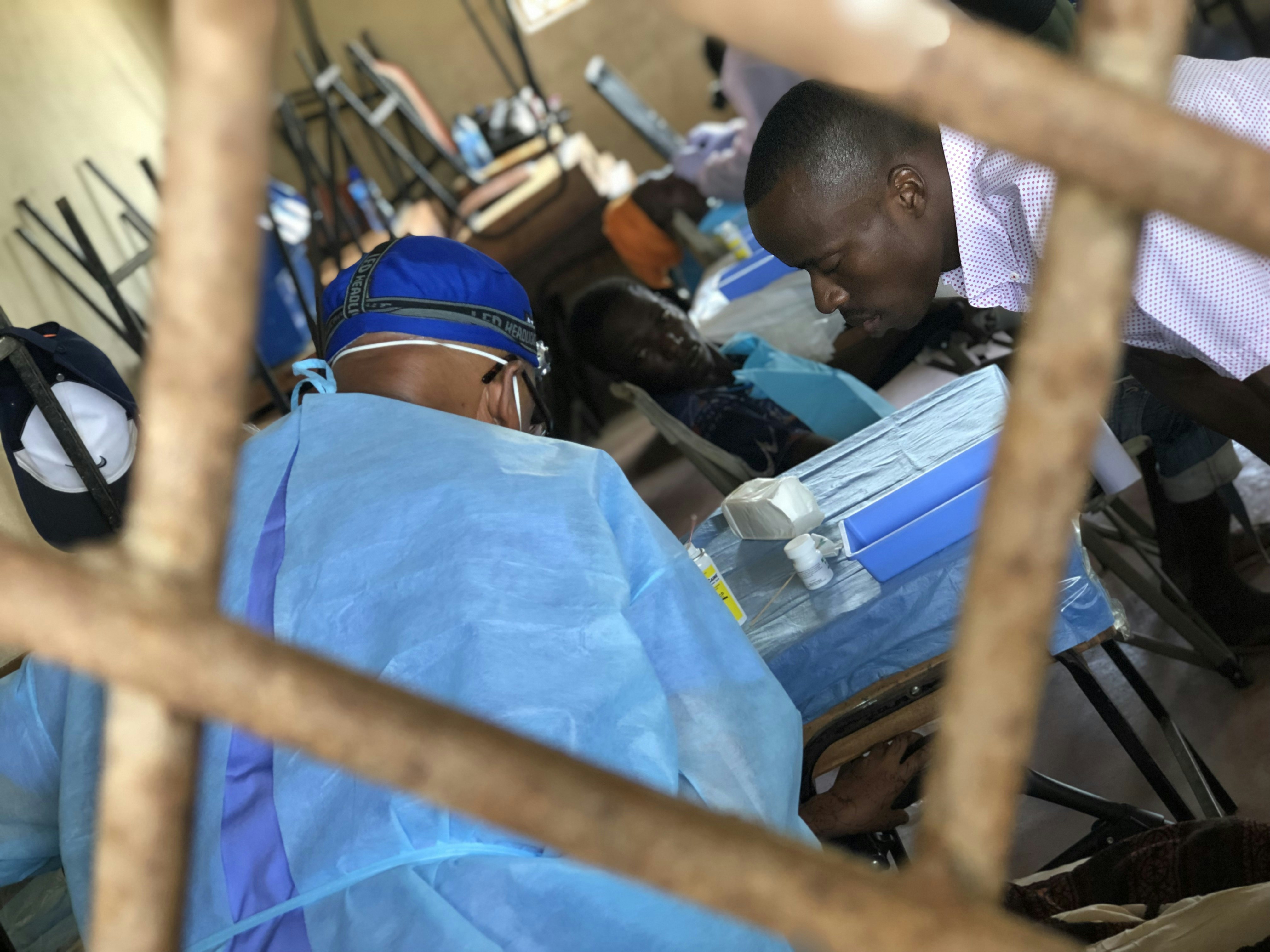 Doctor consulting with patient in modern examination room with soft clinical lighting and blue-toned atmosphere
