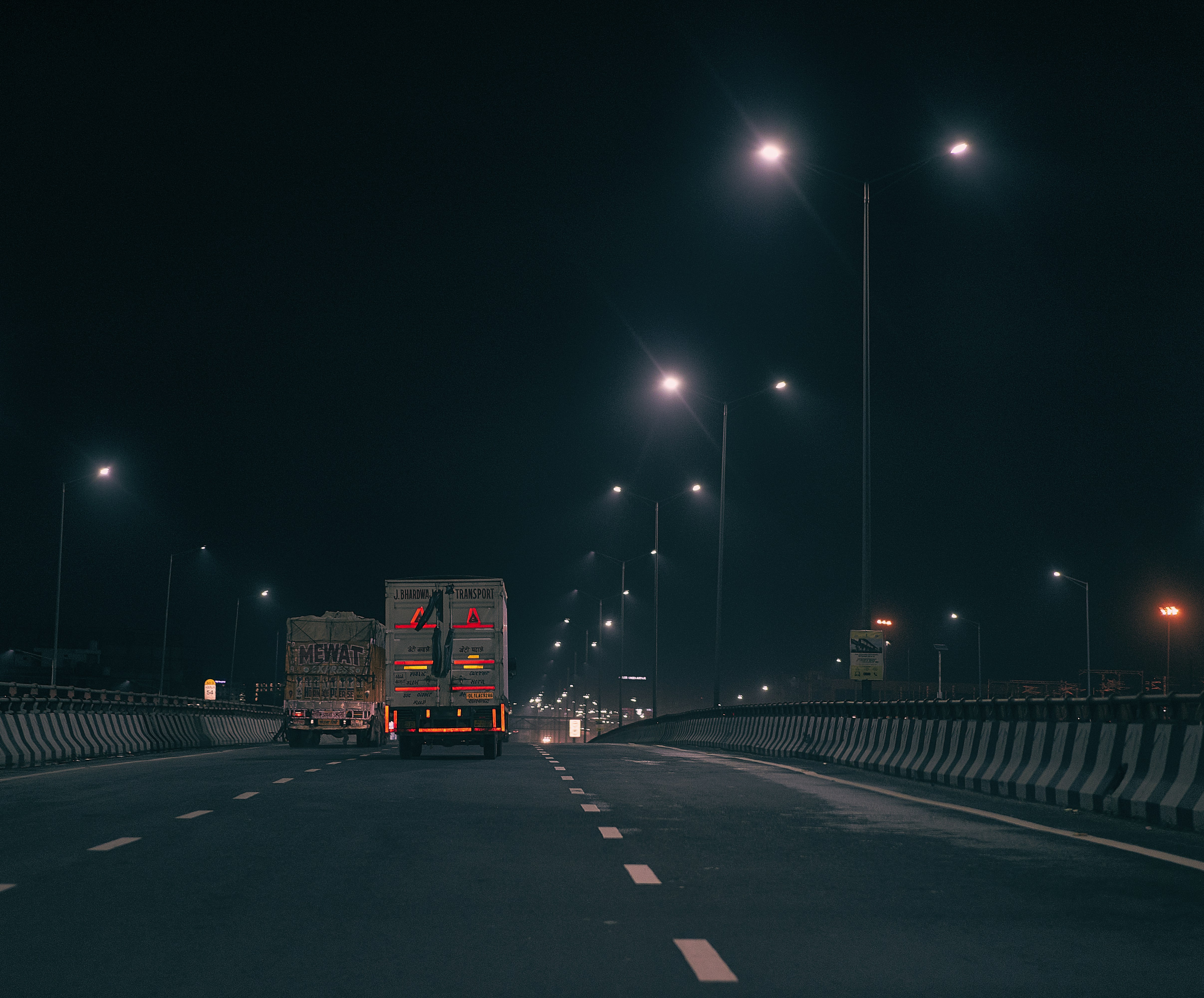 red and white truck on road during night time