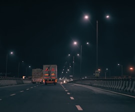 red and white truck on road during night time