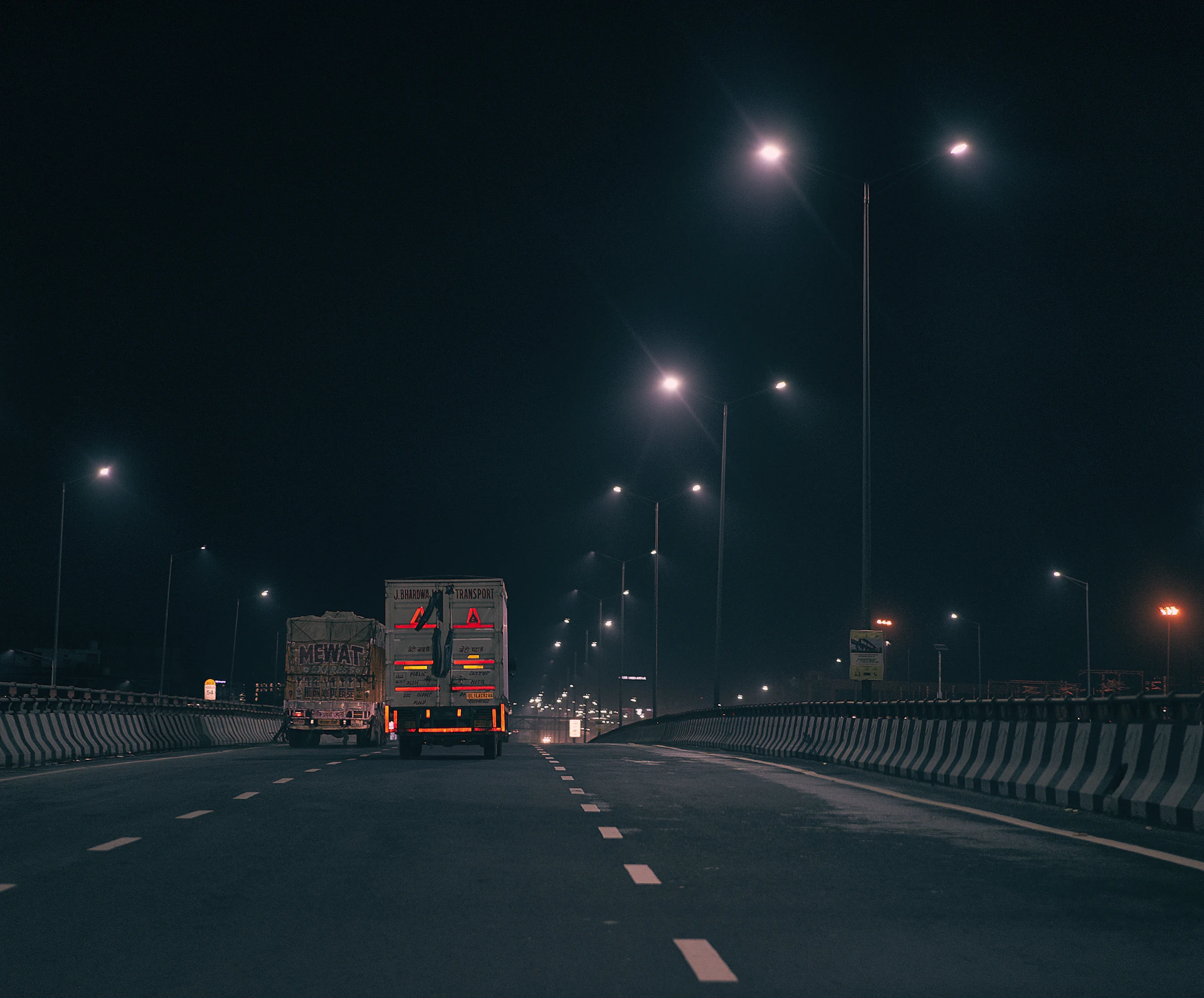 red and white truck on road during night time