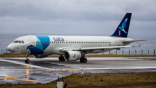 white and blue airplane on airport during daytime