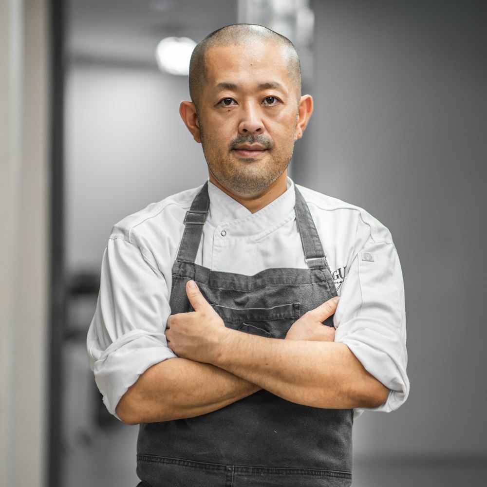 man in white button up shirt and black vest