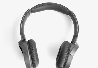 black and silver headphones on white surface