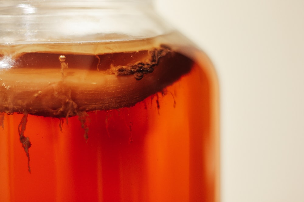 clear glass jar with brown liquid