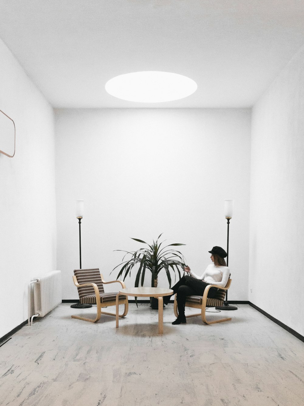 man in black shirt sitting on brown wooden chair