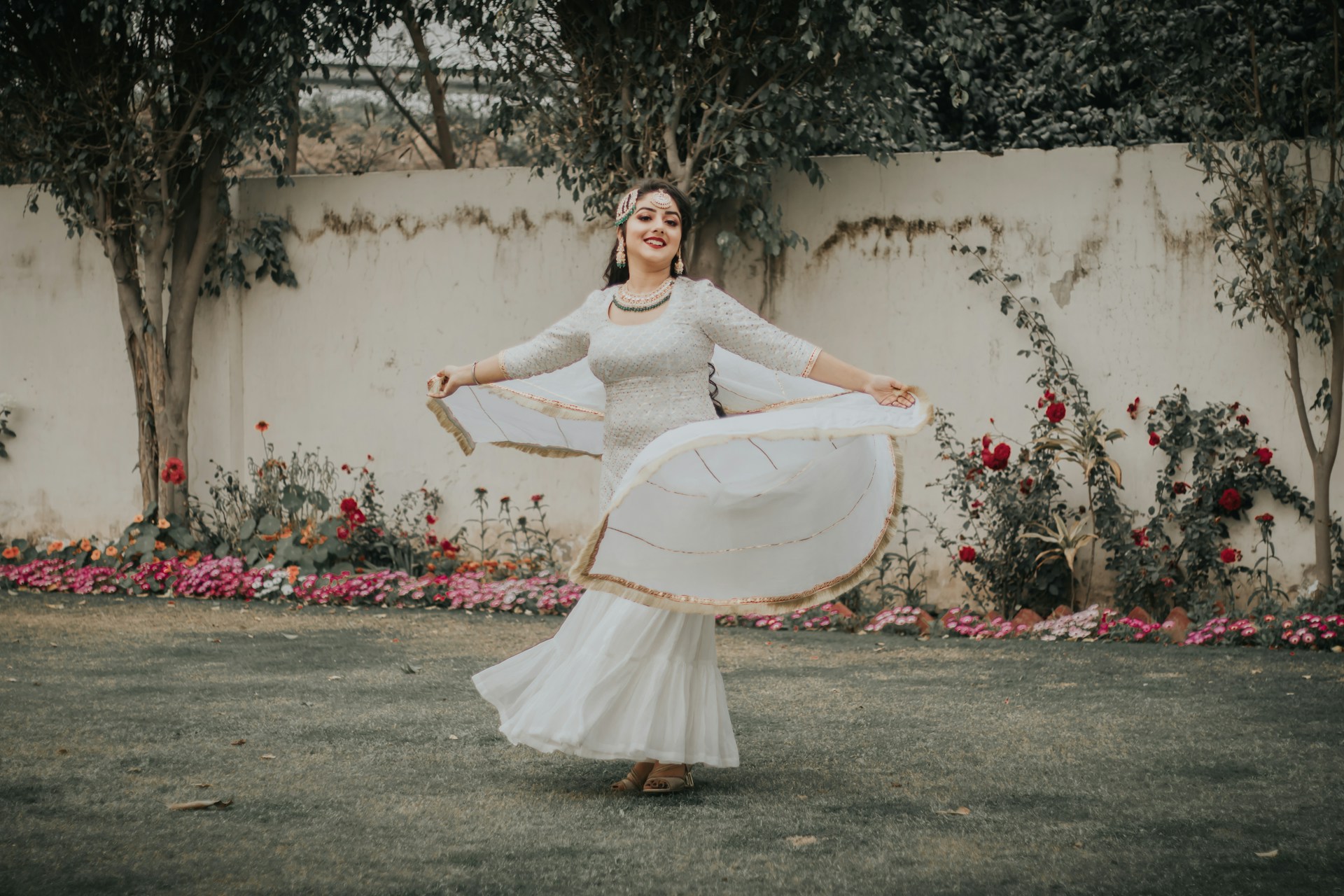 woman in white dress holding white surfboard