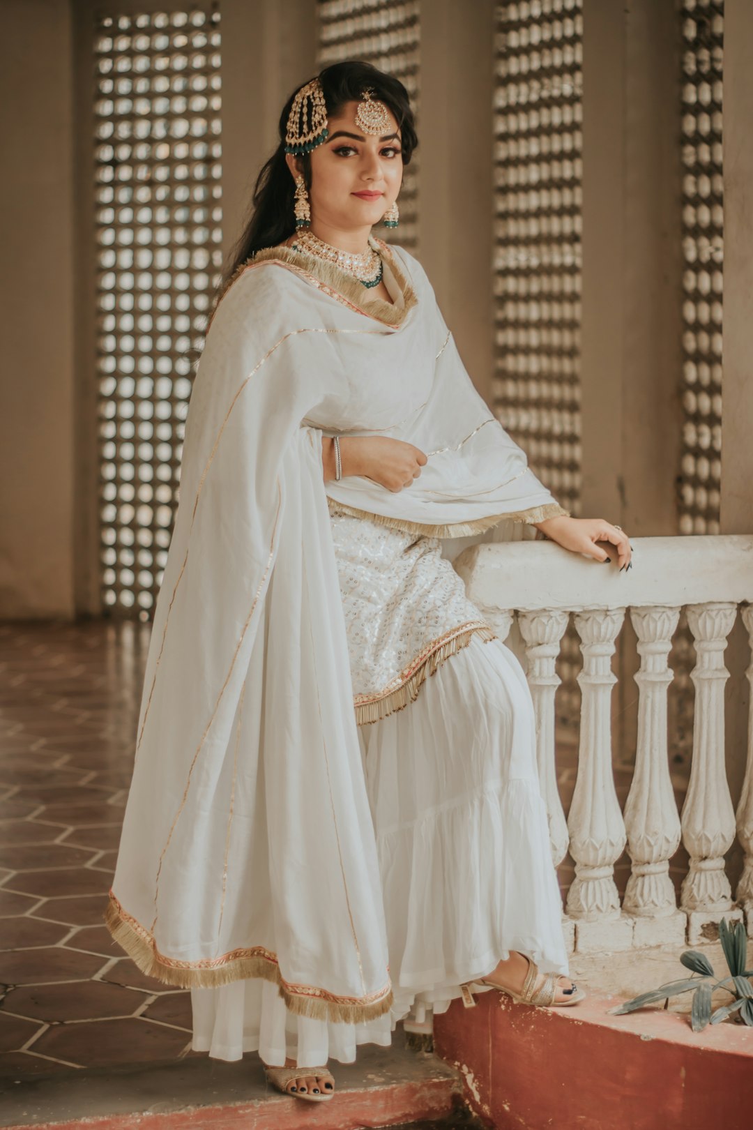 woman in white hijab sitting on white wooden bench