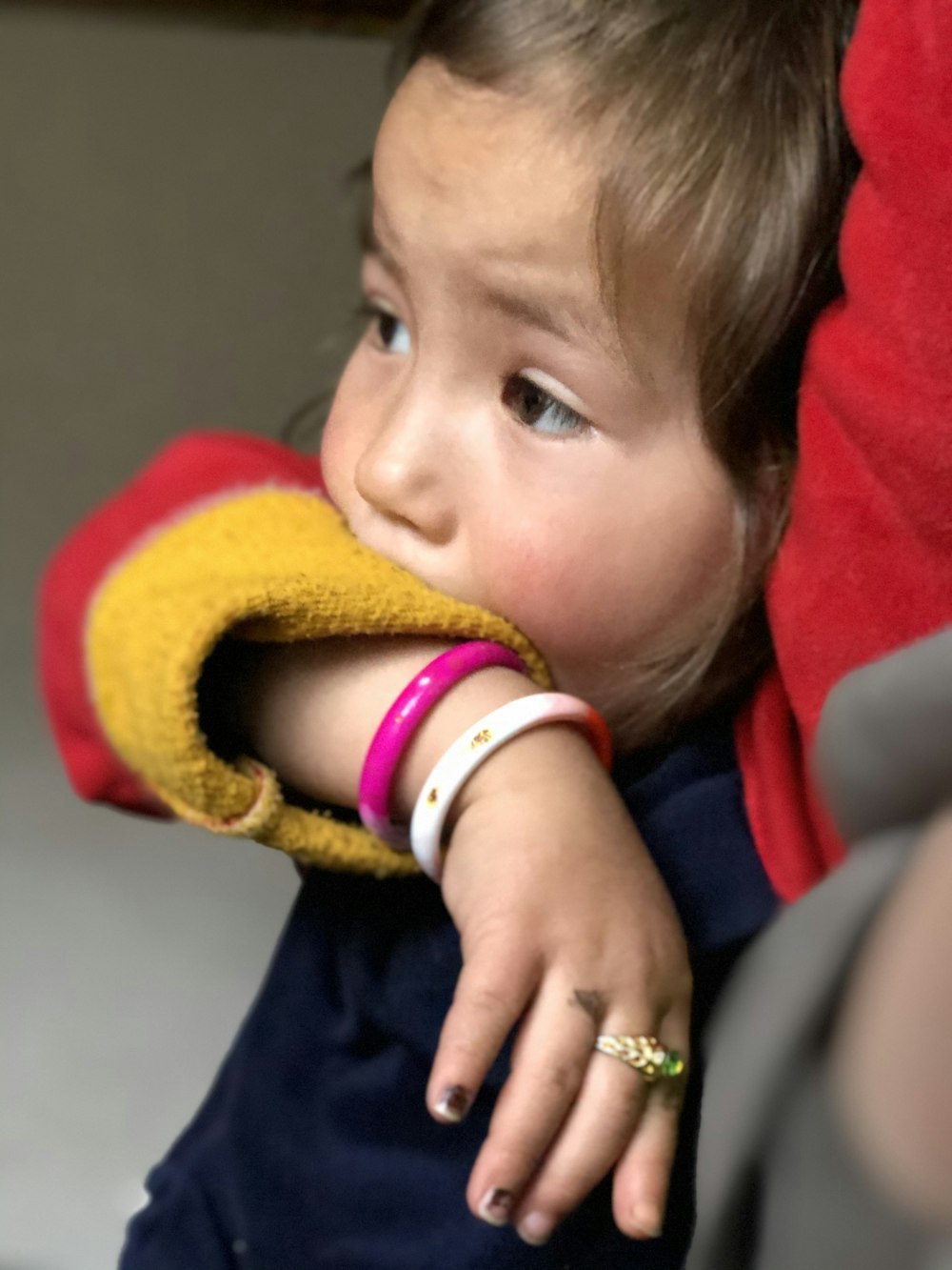 child in red and yellow knit cap