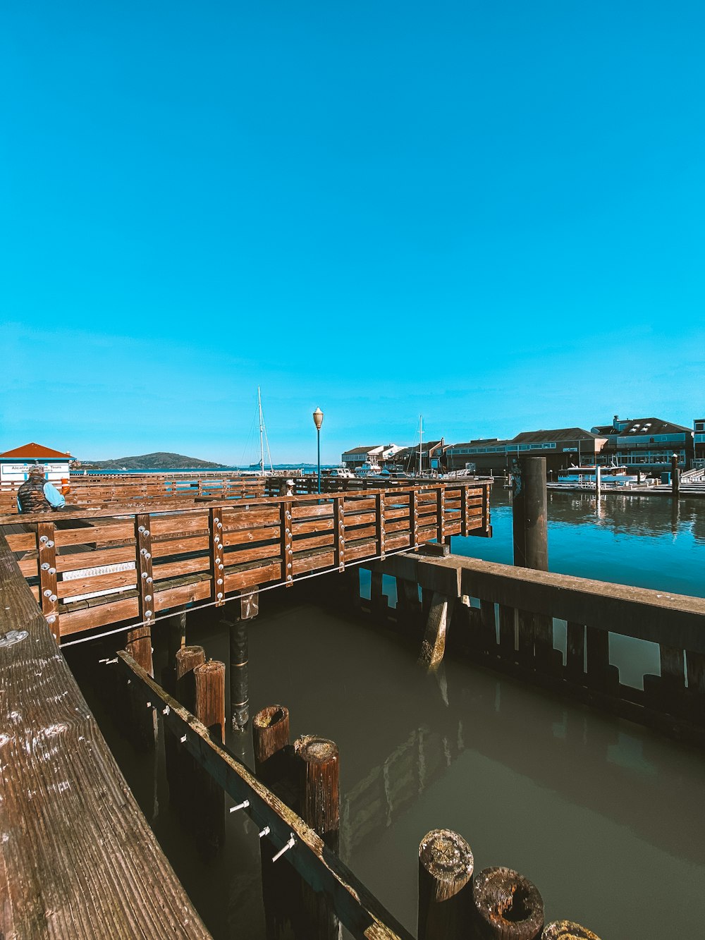 brown wooden dock on body of water during daytime