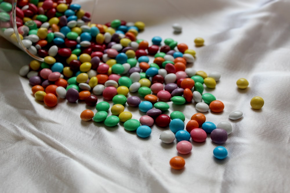 assorted color of beads on white textile