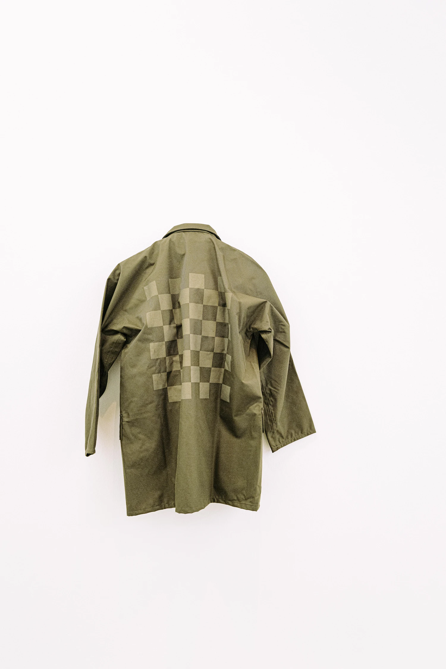 The Corbridge chore coat laid flat on chalk paper in olive cotton drill with patch pockets