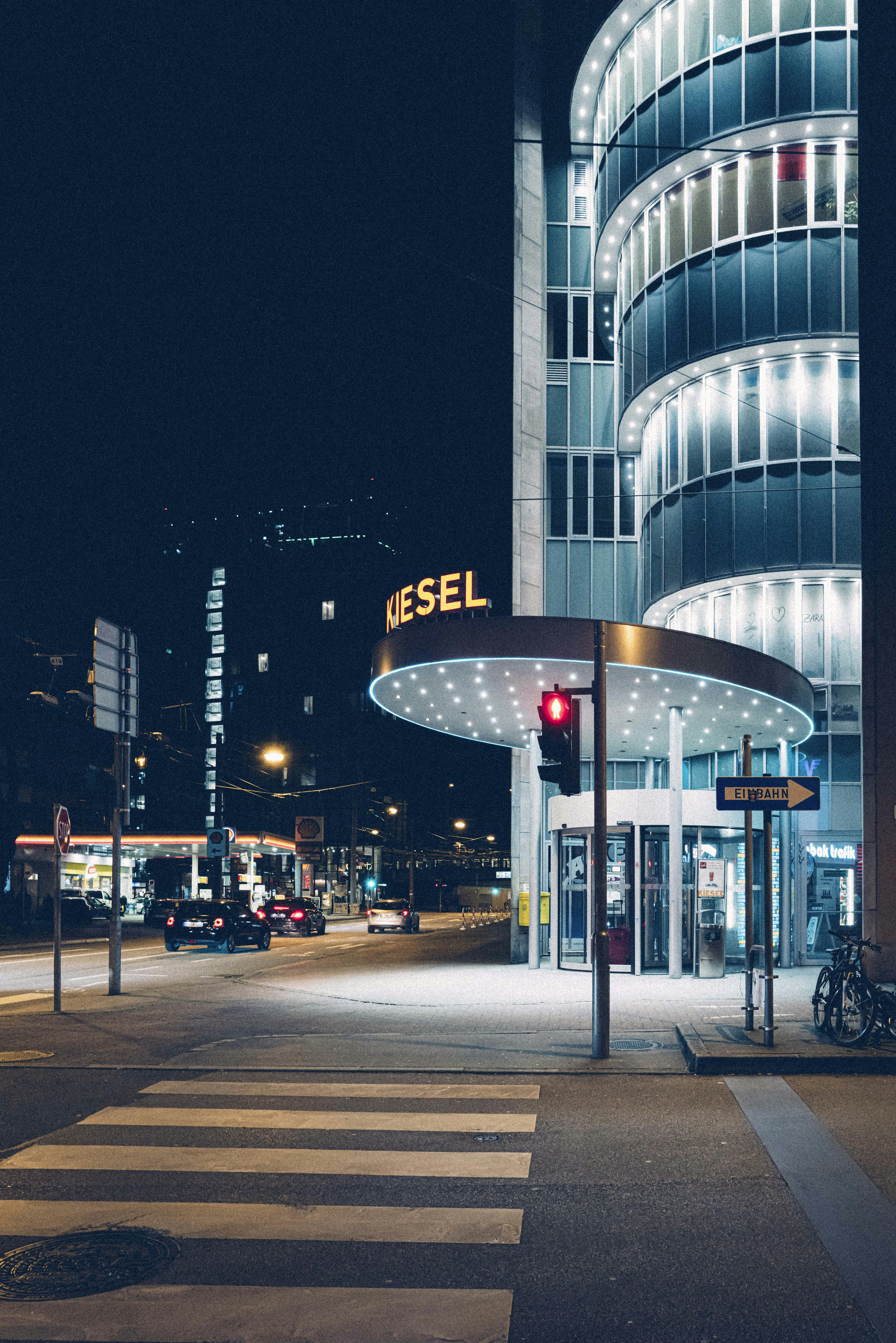 people walking on sidewalk near building during night time