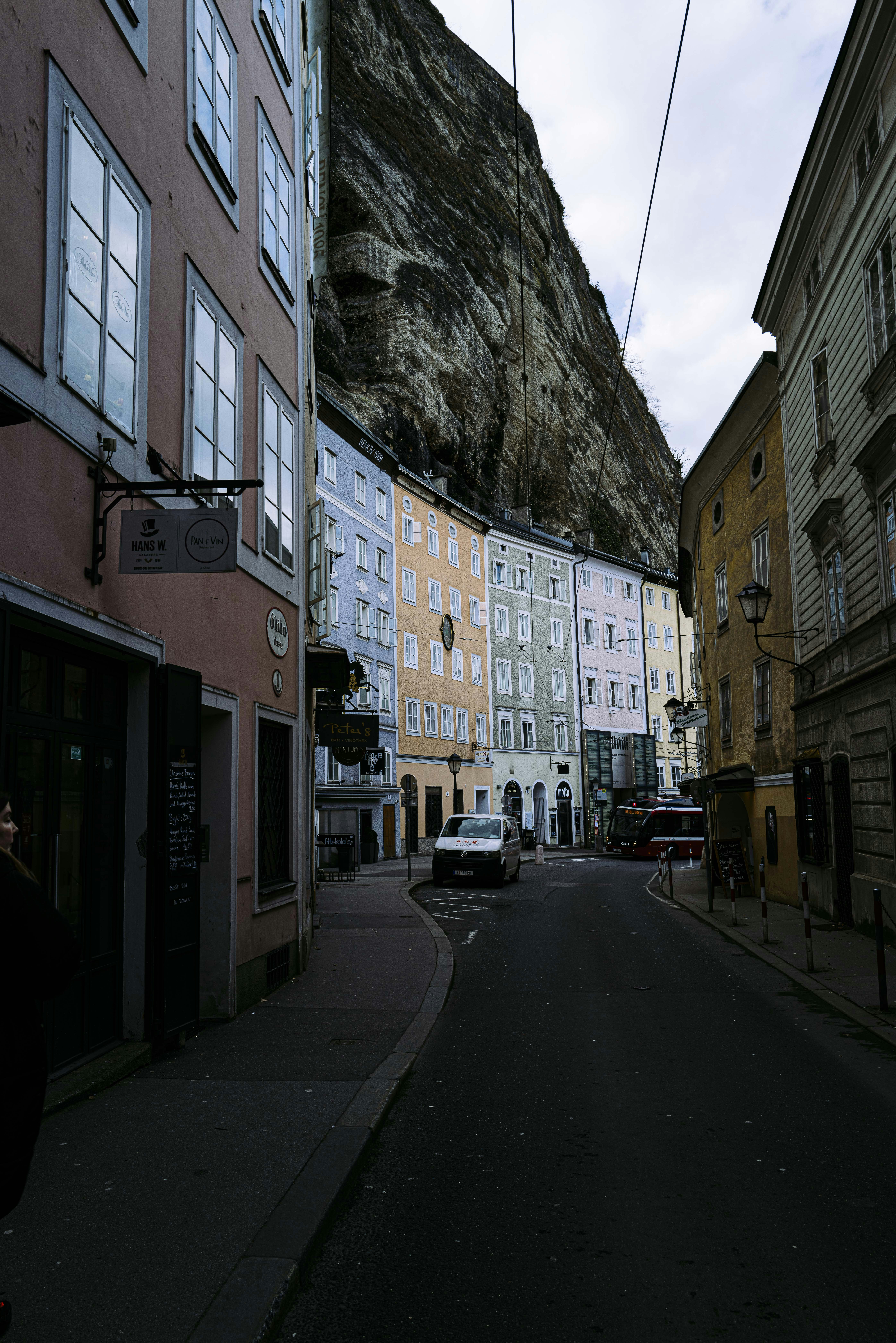 cars parked beside brown concrete building during daytime