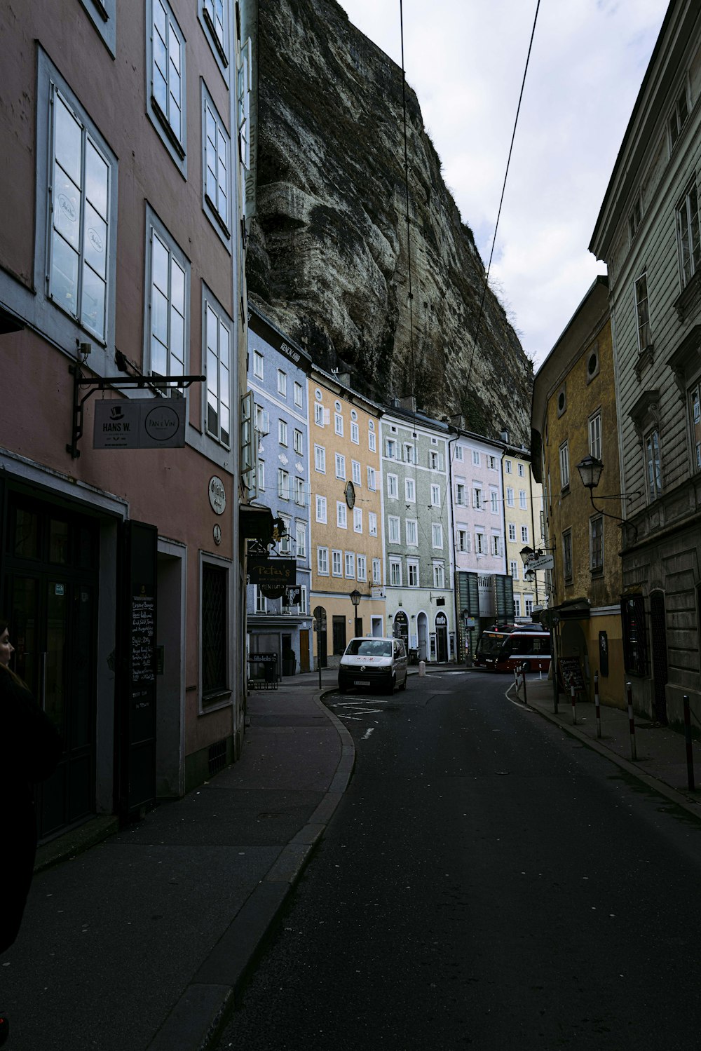 cars parked beside brown concrete building during daytime