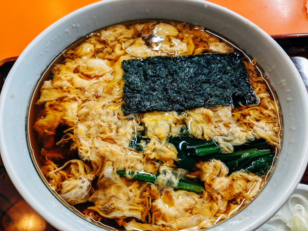 noodles with meat and vegetables in white ceramic bowl