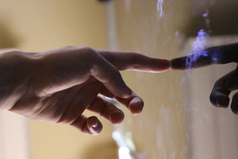 persons hand with white manicure