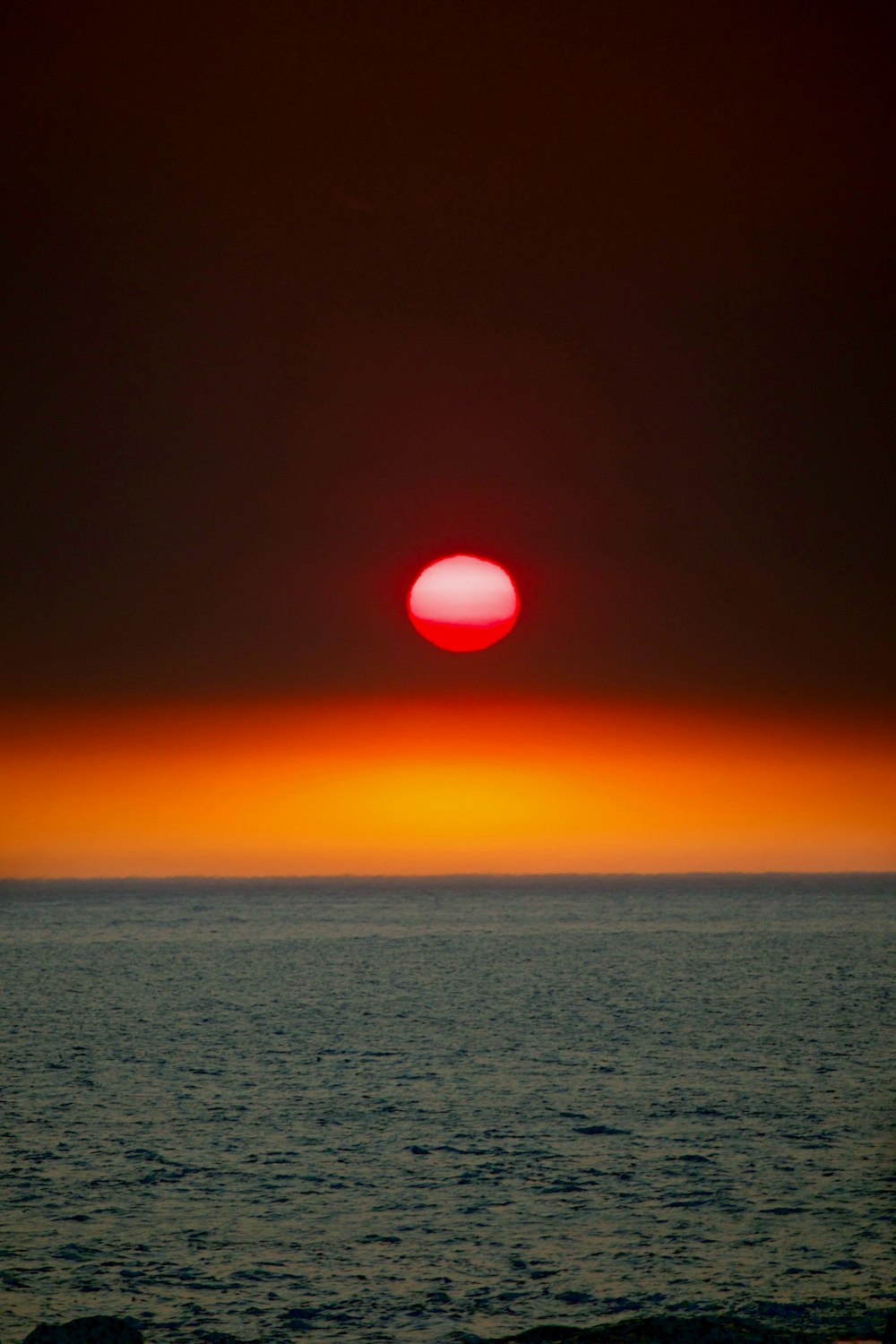 body of water during sunset