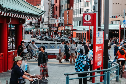 people walking on sidewalk near building during daytime in Asakusa Japan