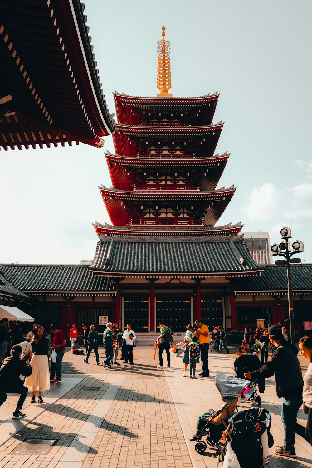 people walking on red and brown temple during daytime