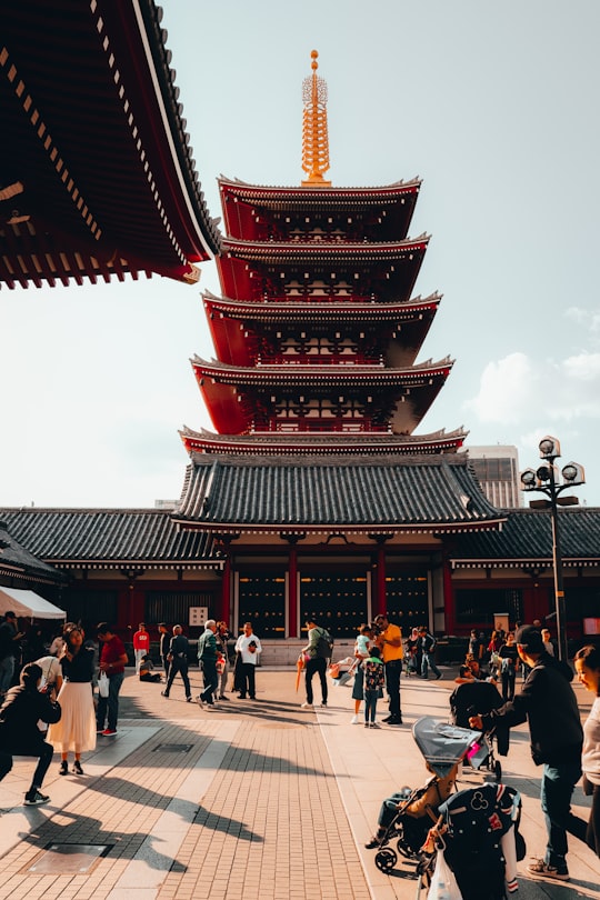 people walking on red and brown temple during daytime in Sensō-ji Japan