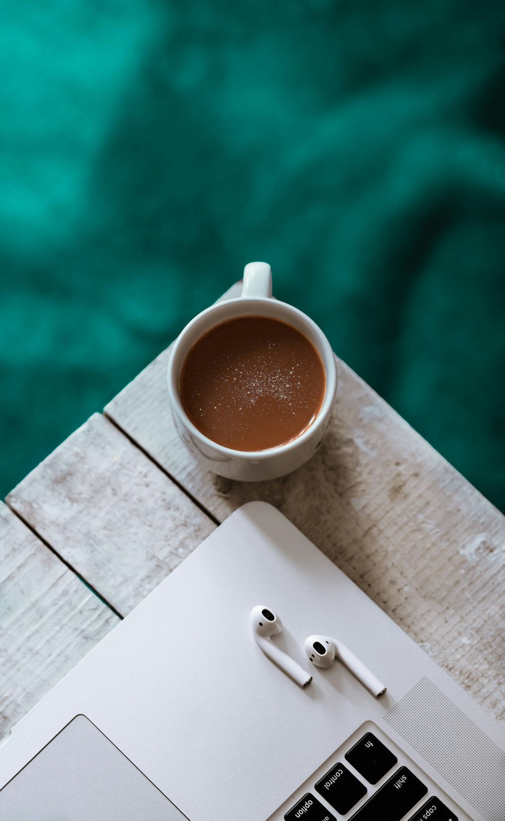 white ceramic mug with brown liquid