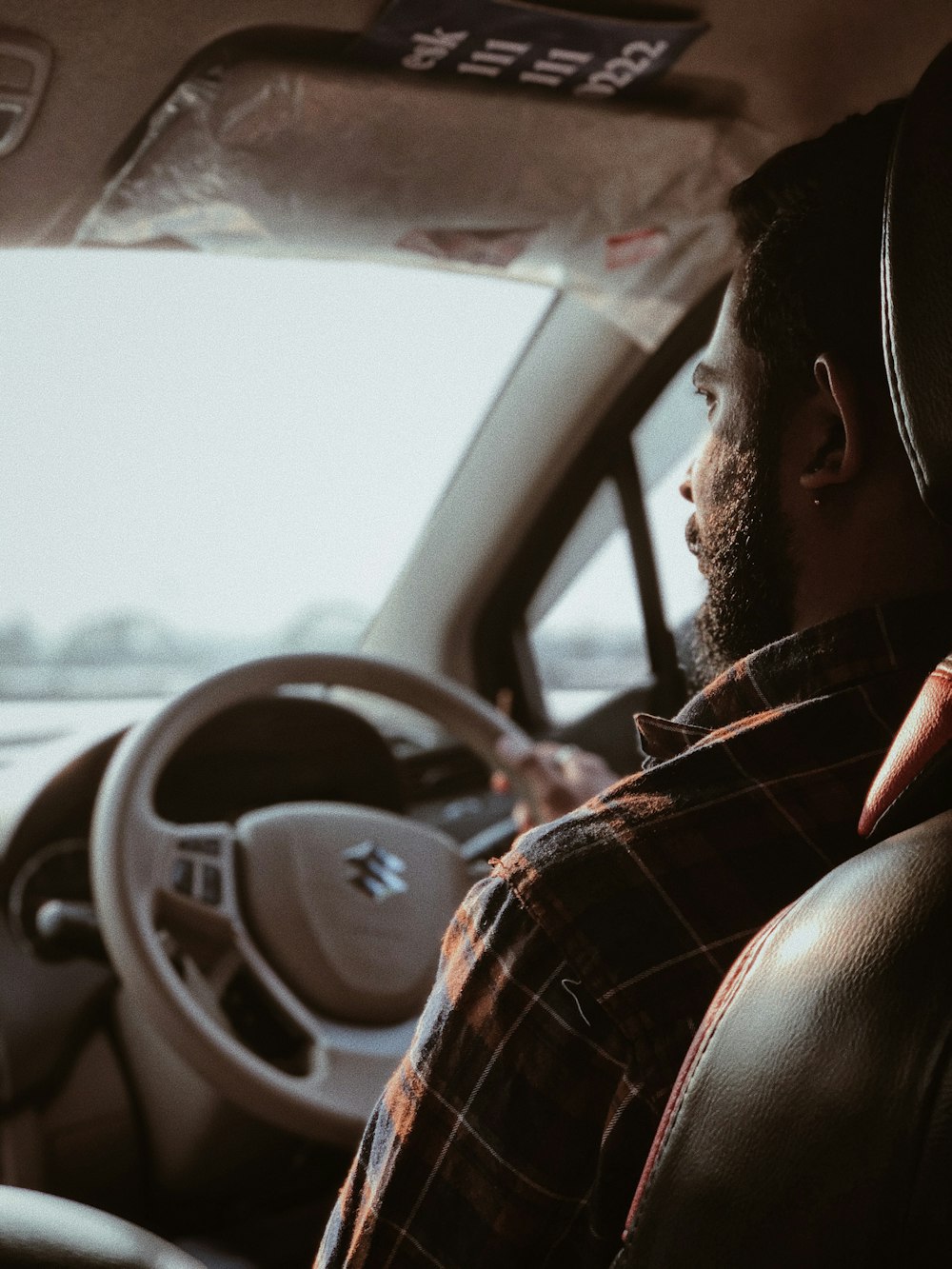 a man sitting in the driver's seat of a car