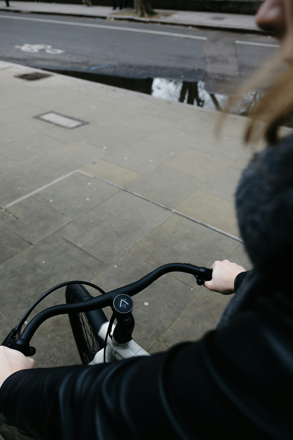 person in black jacket holding black metal rod