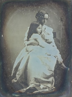 Close-up of a beautifully restored vintage photograph showing a grandparent and child.