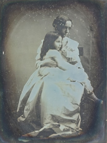 Close-up of a beautifully restored vintage photograph showing a grandparent and child.