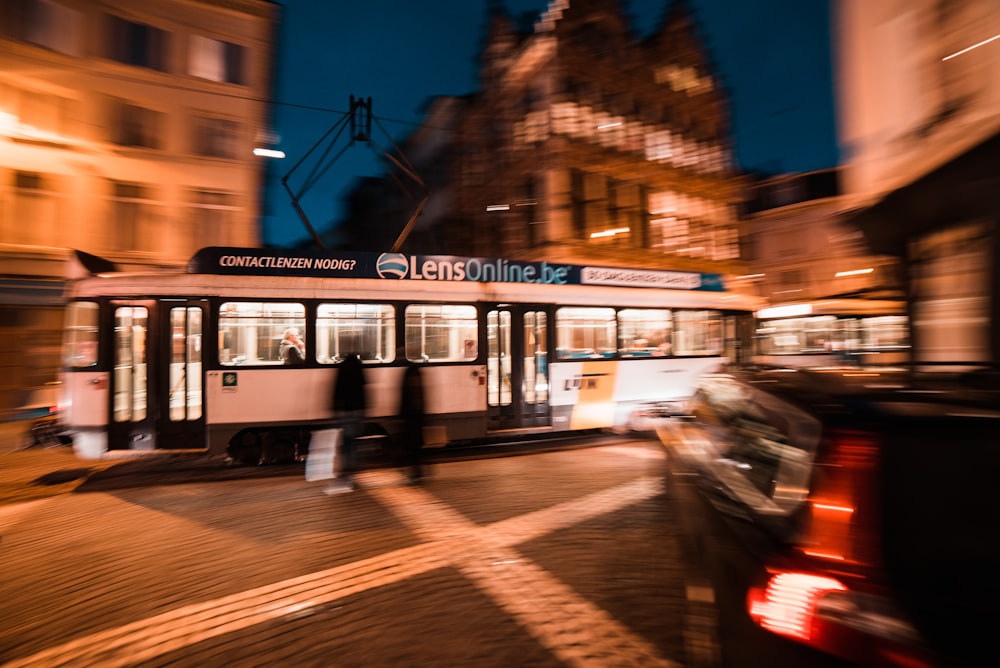 white and black tram on road during night time