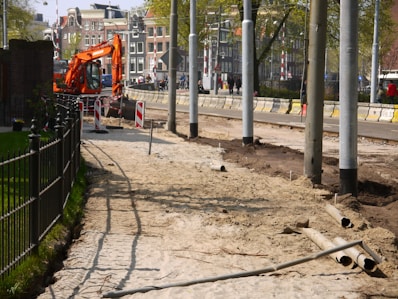 orange and black metal frame near black metal fence during daytime