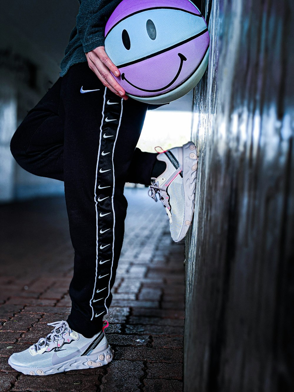 person in black pants and black and white sneakers