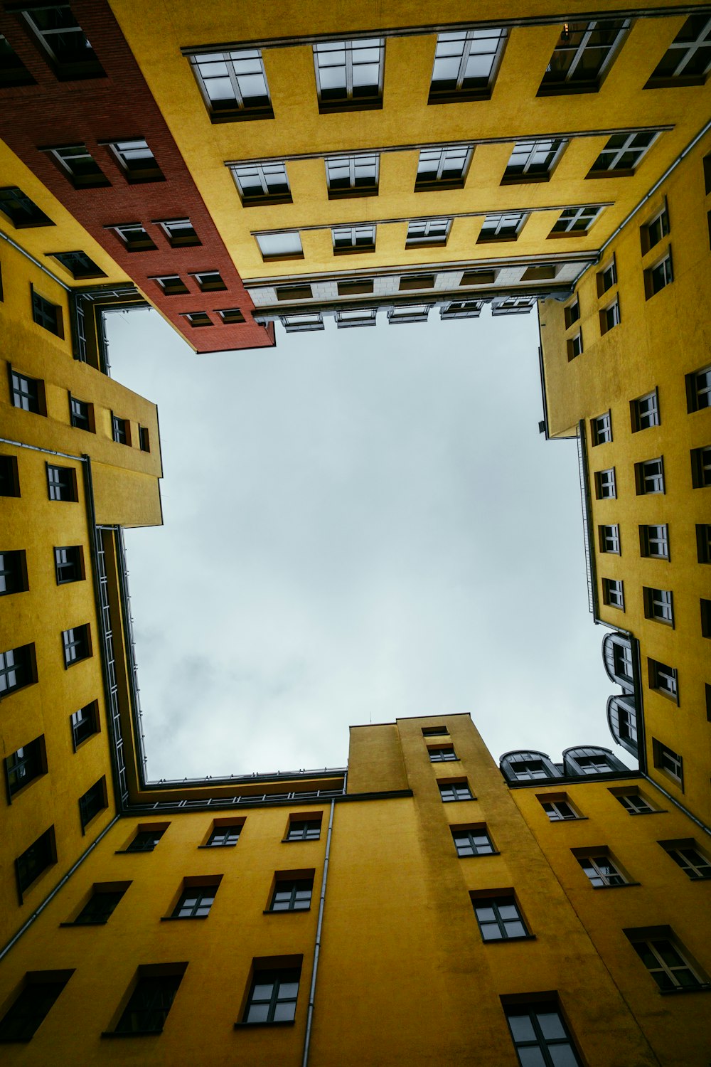 brown concrete building under white clouds during daytime