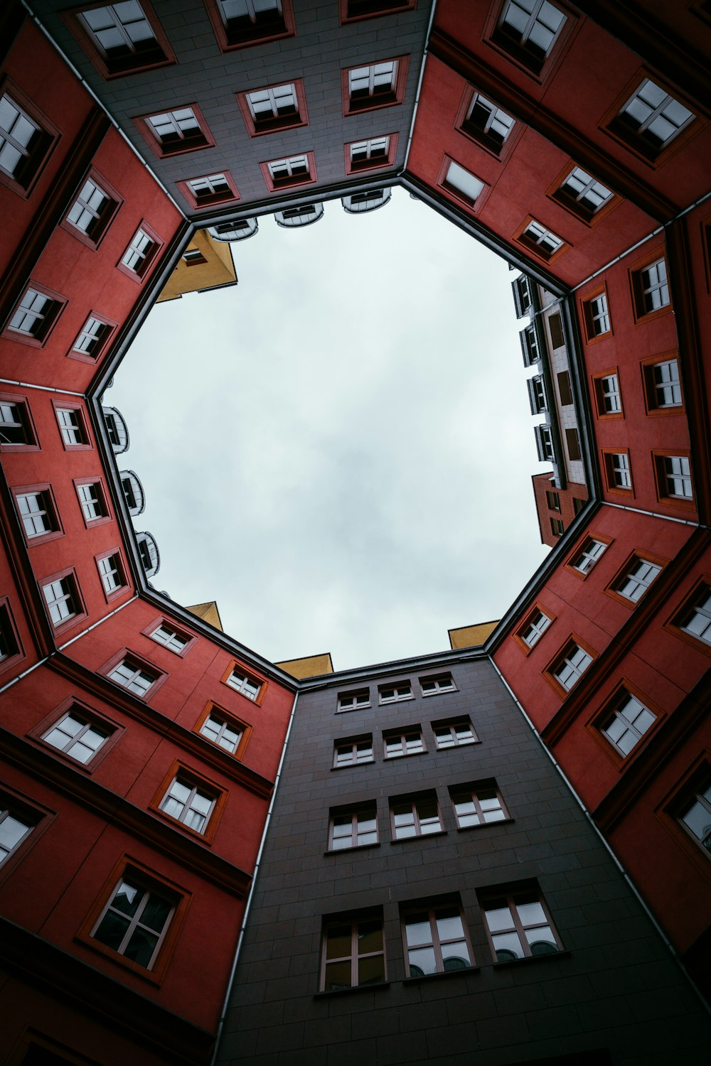 brown and white concrete building under white clouds during daytime