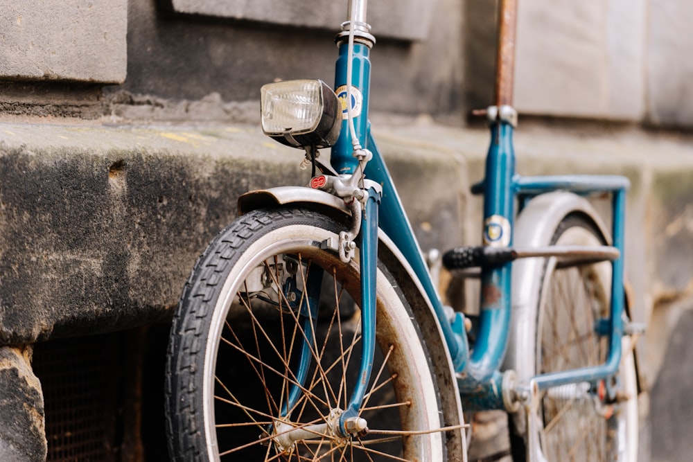 blue and black bicycle with white plastic bottle