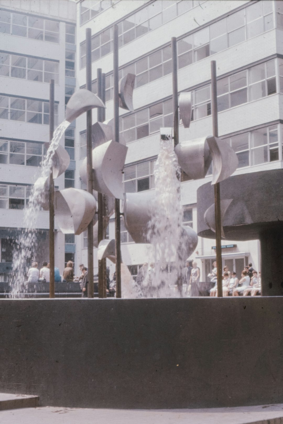 white concrete fountain near white concrete building during daytime