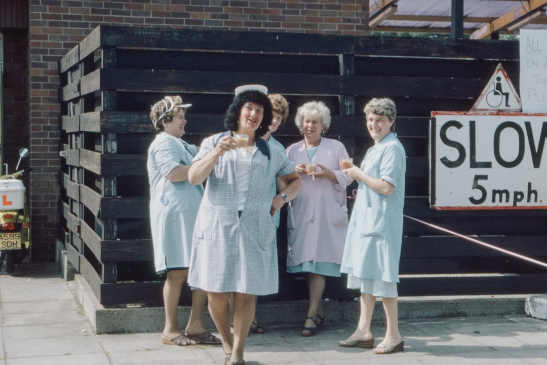 3 women in white dress standing on sidewalk during daytime