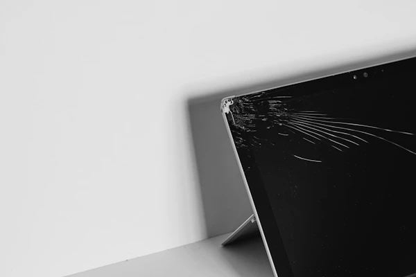 A laptop on a repair bench being prepared for a screen replacement