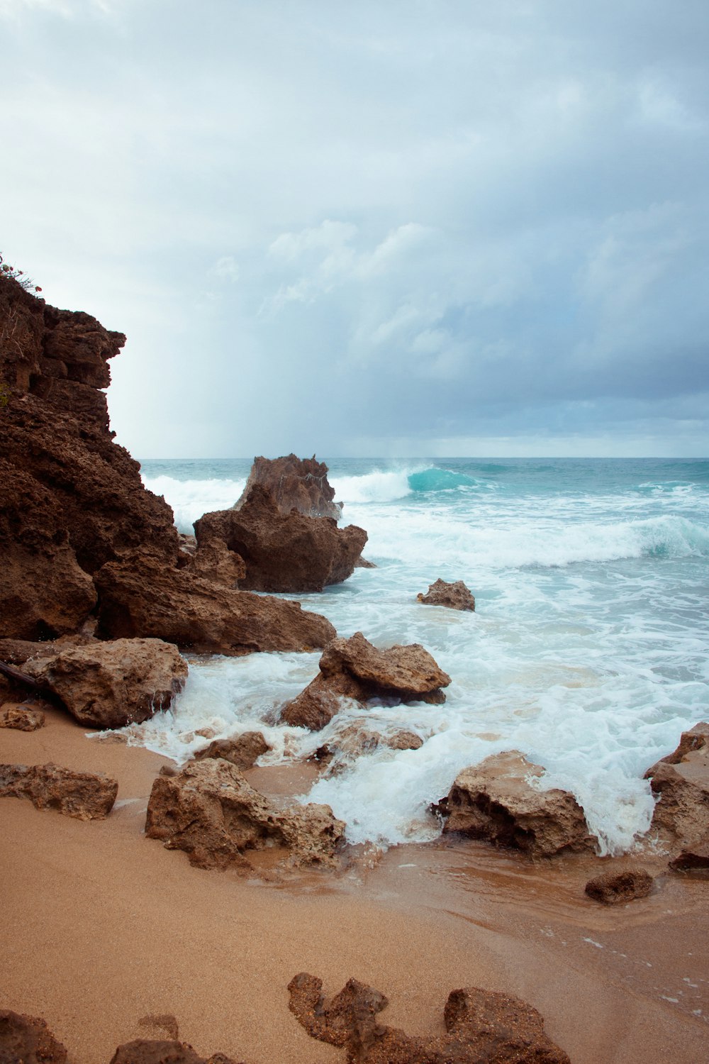 brown rock formation on sea shore during daytime