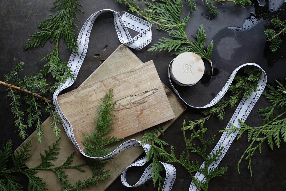 brown wooden chopping board on green leaves