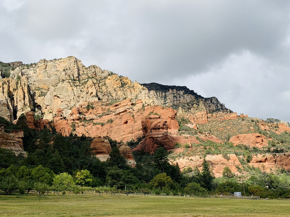 brown rocky mountain under cloudy sky during daytime