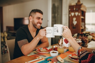 man in black crew neck t-shirt holding white ceramic mug