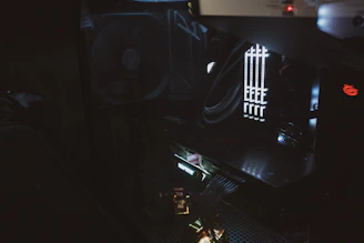 Hands assembling a PC with careful cable management and installation tools.