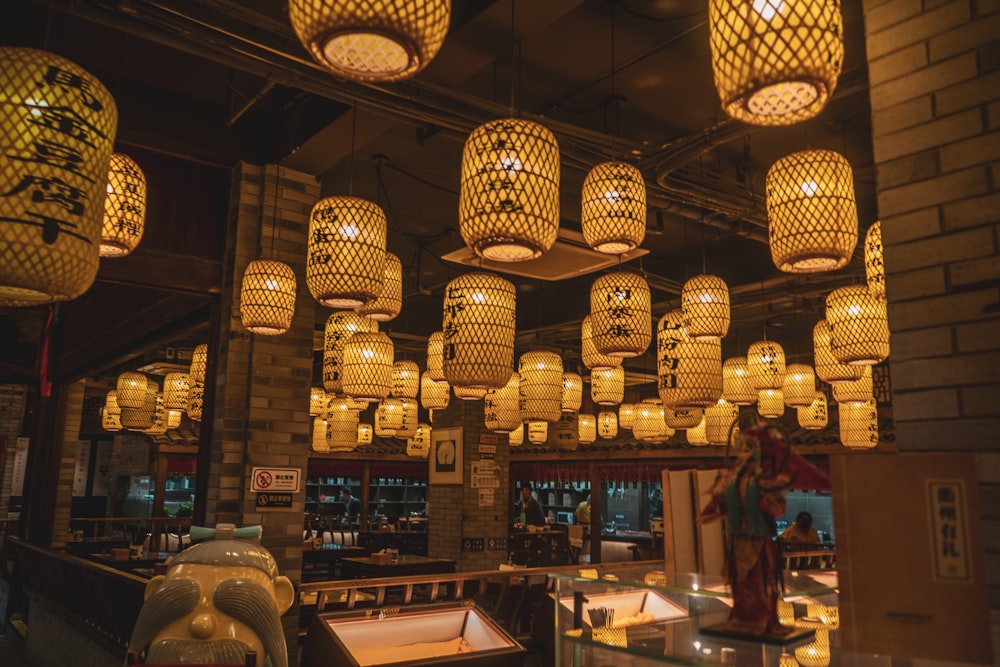 brown pendant lamps turned on inside restaurant