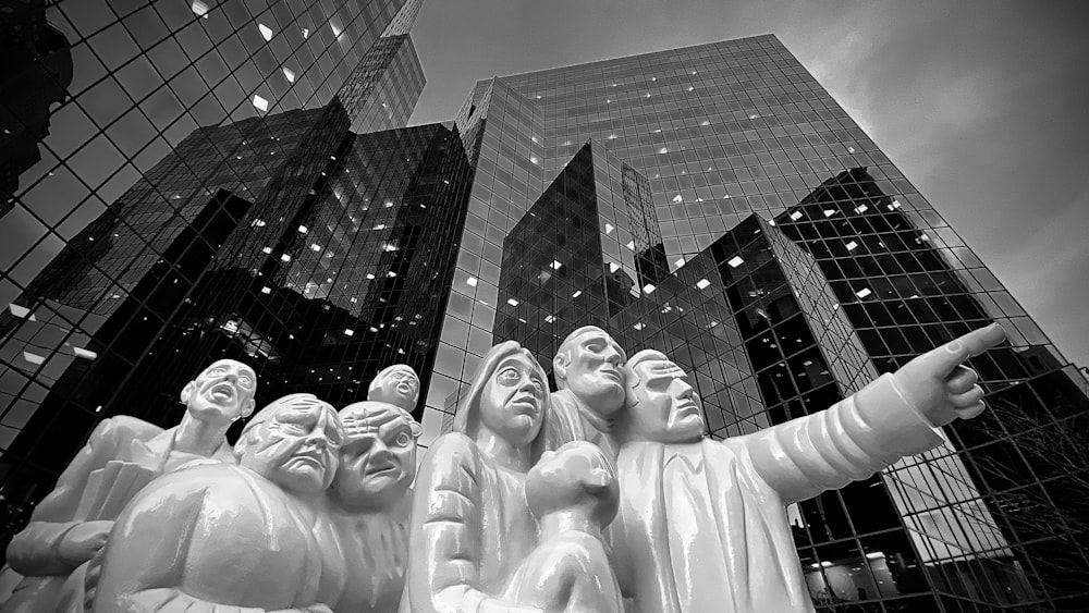 grayscale photo of concrete statue of man