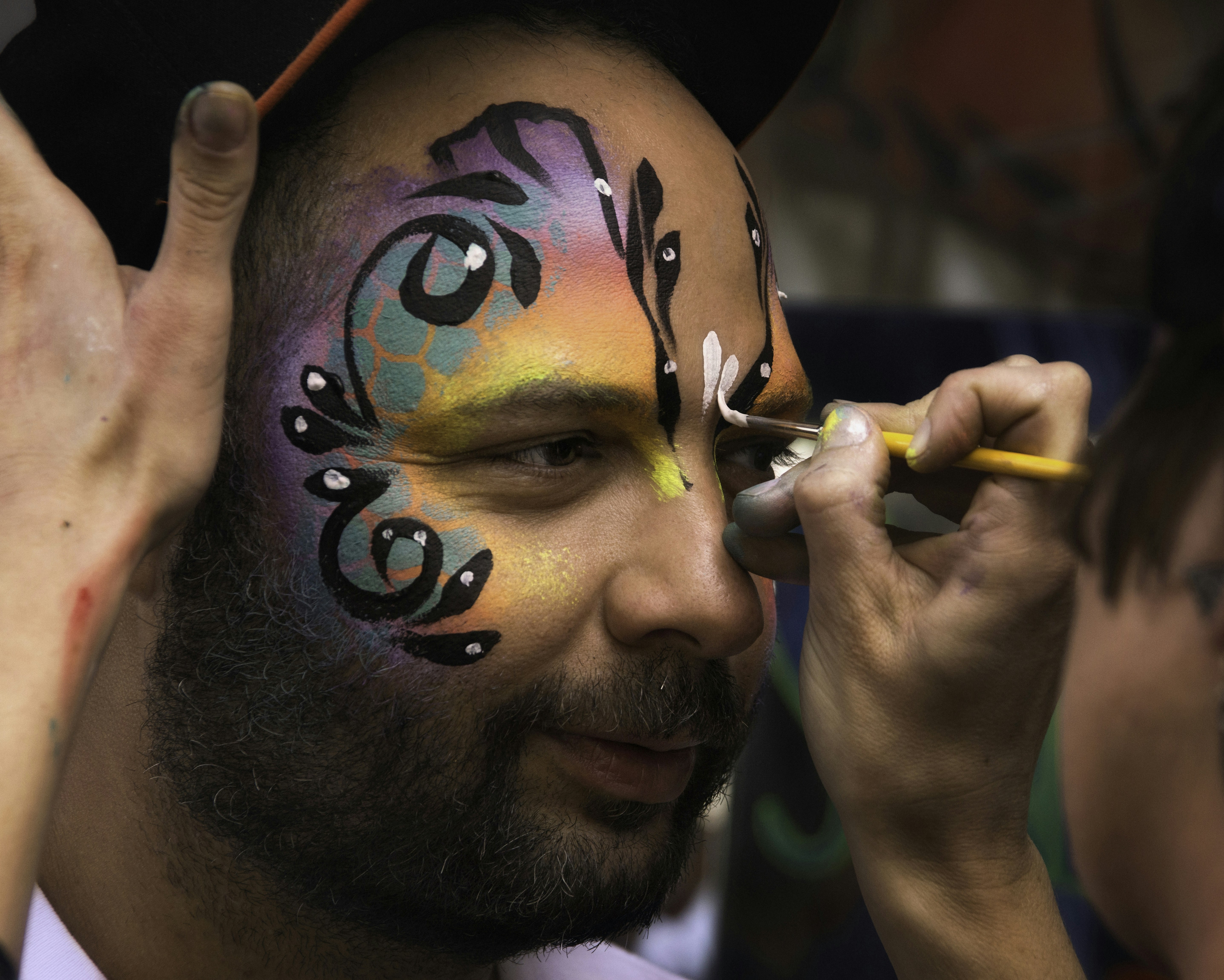 man in black hat holding red pen, Festival Face Painting (Hon Fest Baltimore)