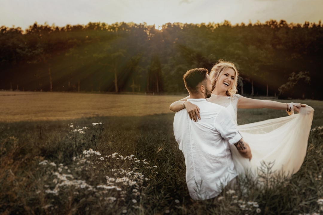 woman in white dress standing on grass field during daytime