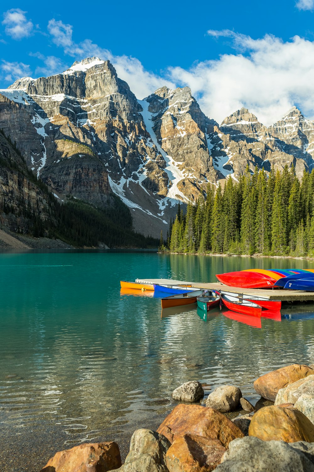 Kayak rouge et bleu sur le lac près de la chaîne de montagnes